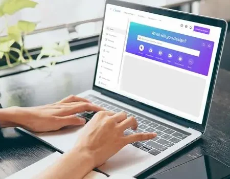 Laptop screen showing Canva dashboard with a person creating a digital product for sale