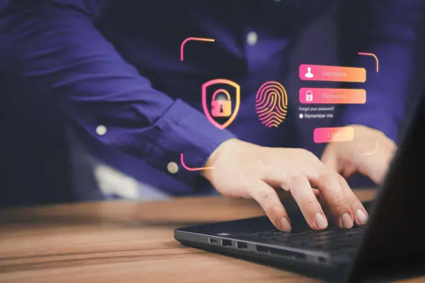 Man Typing passwords, implementing Two-Factor Authentication