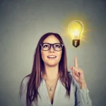 creative idea light bulb above open laptop