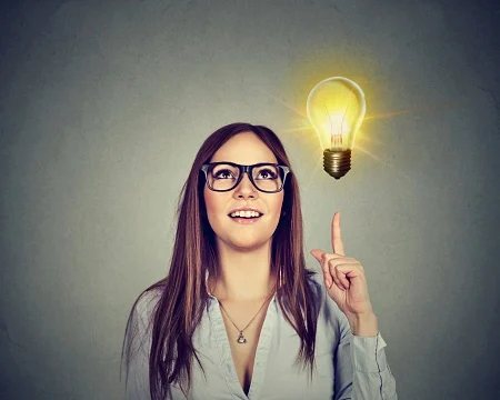 creative idea light bulb above open laptop