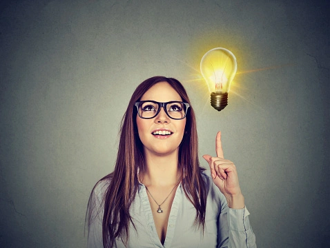 creative idea light bulb above open laptop